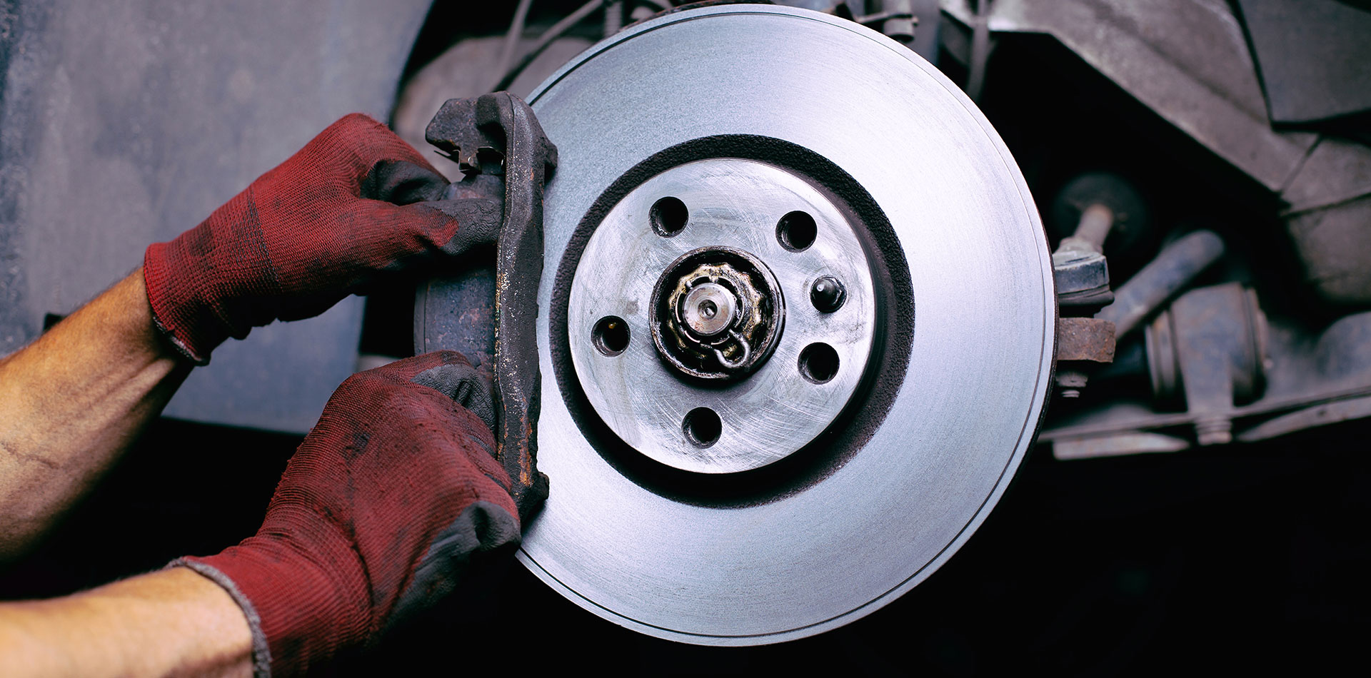 a man is fixing a broken up radiator  serviced by Brake Pros of Waltham in Arlington specializing in brake pad replacement.