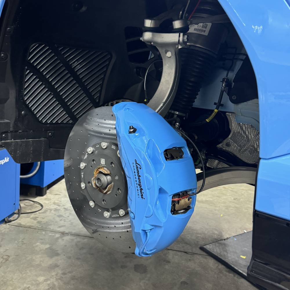 a blue and yellow motorcycle with a blue and yellow tail  serviced by Brake Pros of Waltham in Waltham, MA specializing in German car brake specialist.