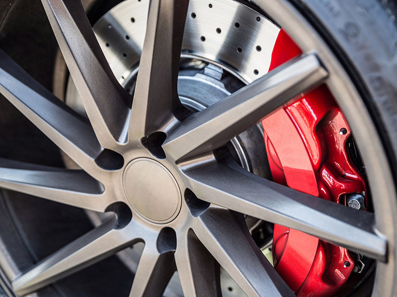 a red and black tire  serviced by Brake Pros of Waltham in Cambridge specializing in ASE-certified technicians.