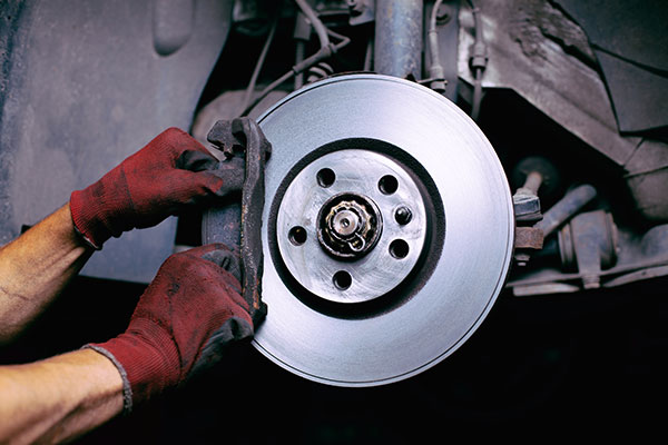 a man fixing a broken up radiator  serviced by Brake Pros of Waltham in Billerica specializing in brake fluid change.