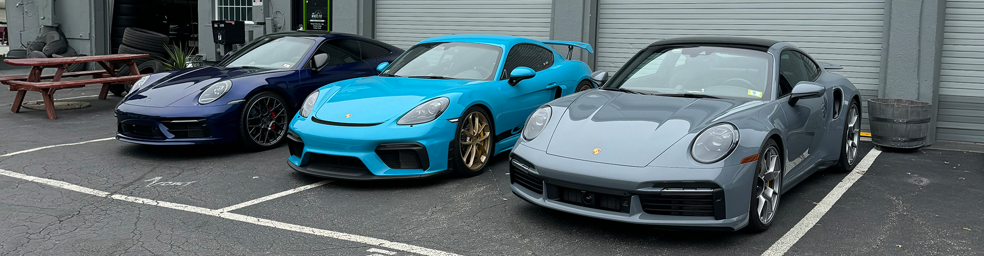 a blue car parked next to a white car  serviced by Brake Pros of Waltham in Waltham, MA specializing in brake rotor servicing.