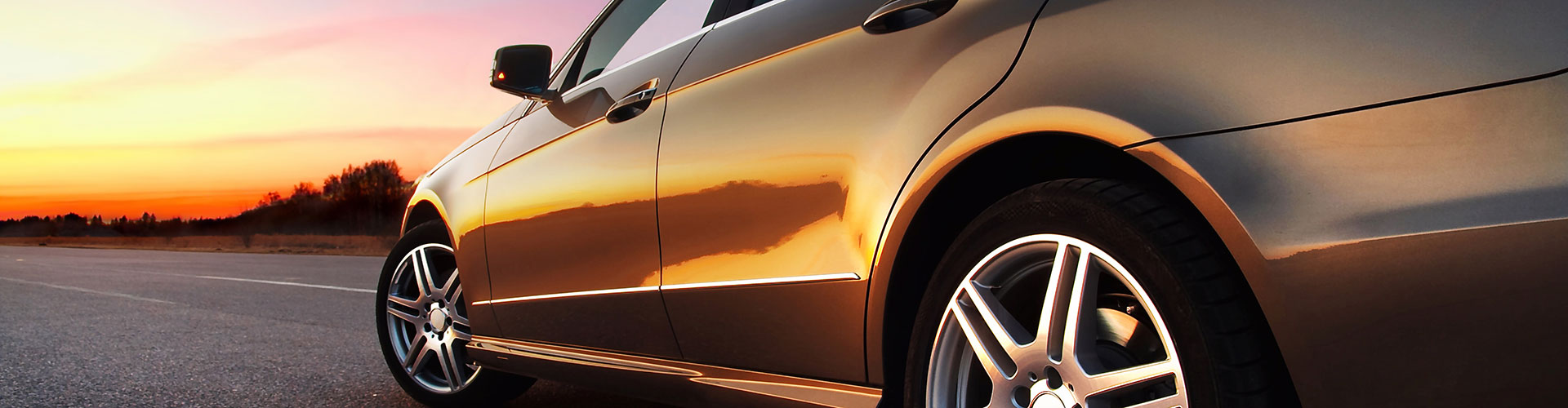 a car parked in a parking lot with a sky background  serviced by Brake Pros of Waltham in Acton specializing in brake repair Waltham.