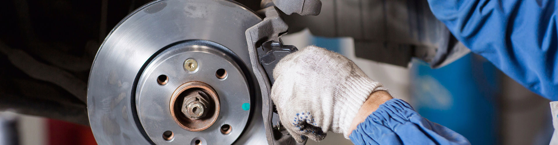 a man fixing a broken up motorcycle  serviced by Brake Pros of Waltham in Everett specializing in German car brake specialist.