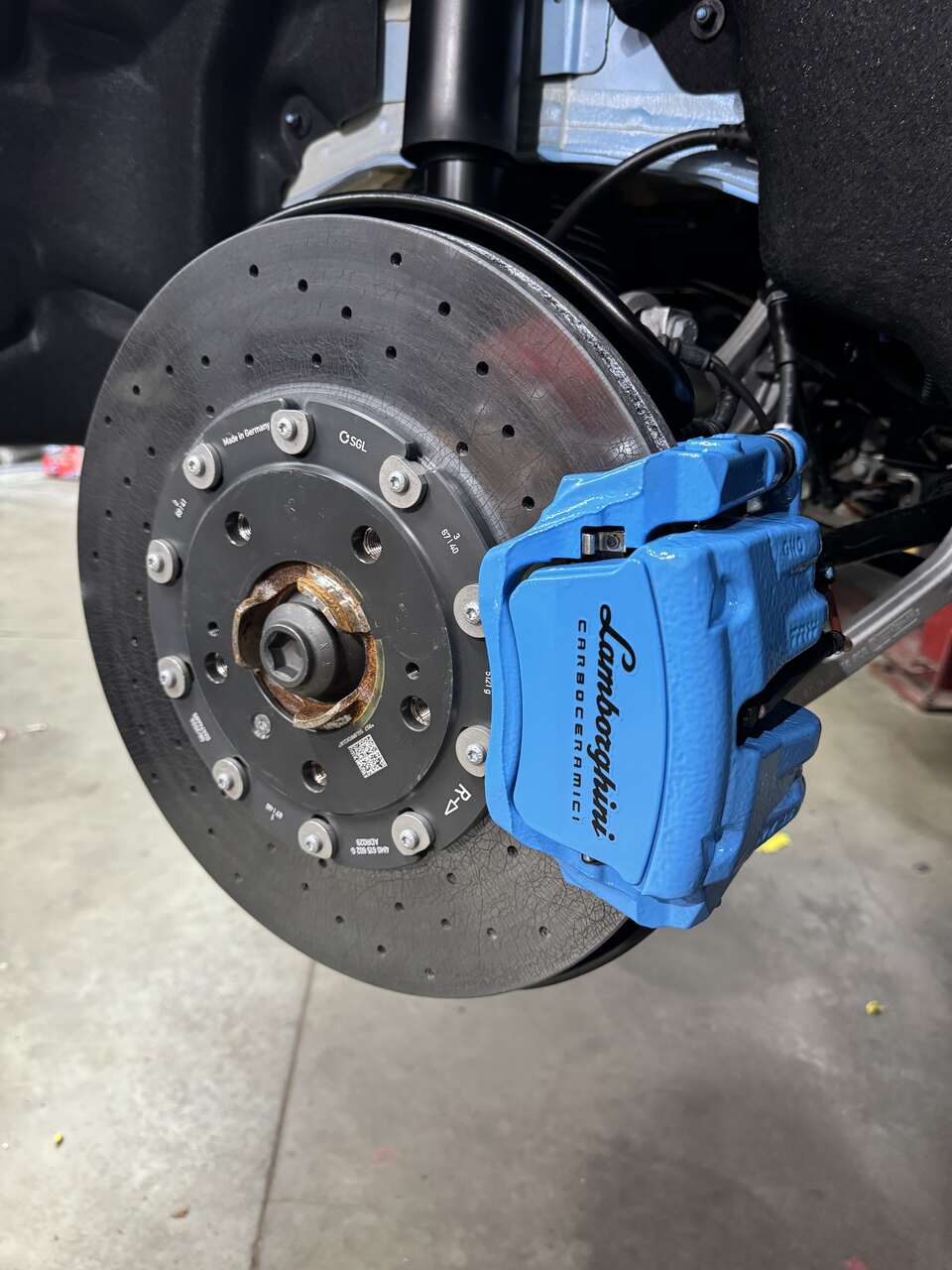 a blue and black tire brake  serviced by Brake Pros of Waltham in Framingham specializing in brake caliper painting.