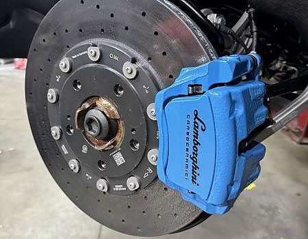 a blue and black tire brake  serviced by Brake Pros of Waltham in Framingham specializing in brake caliper painting.