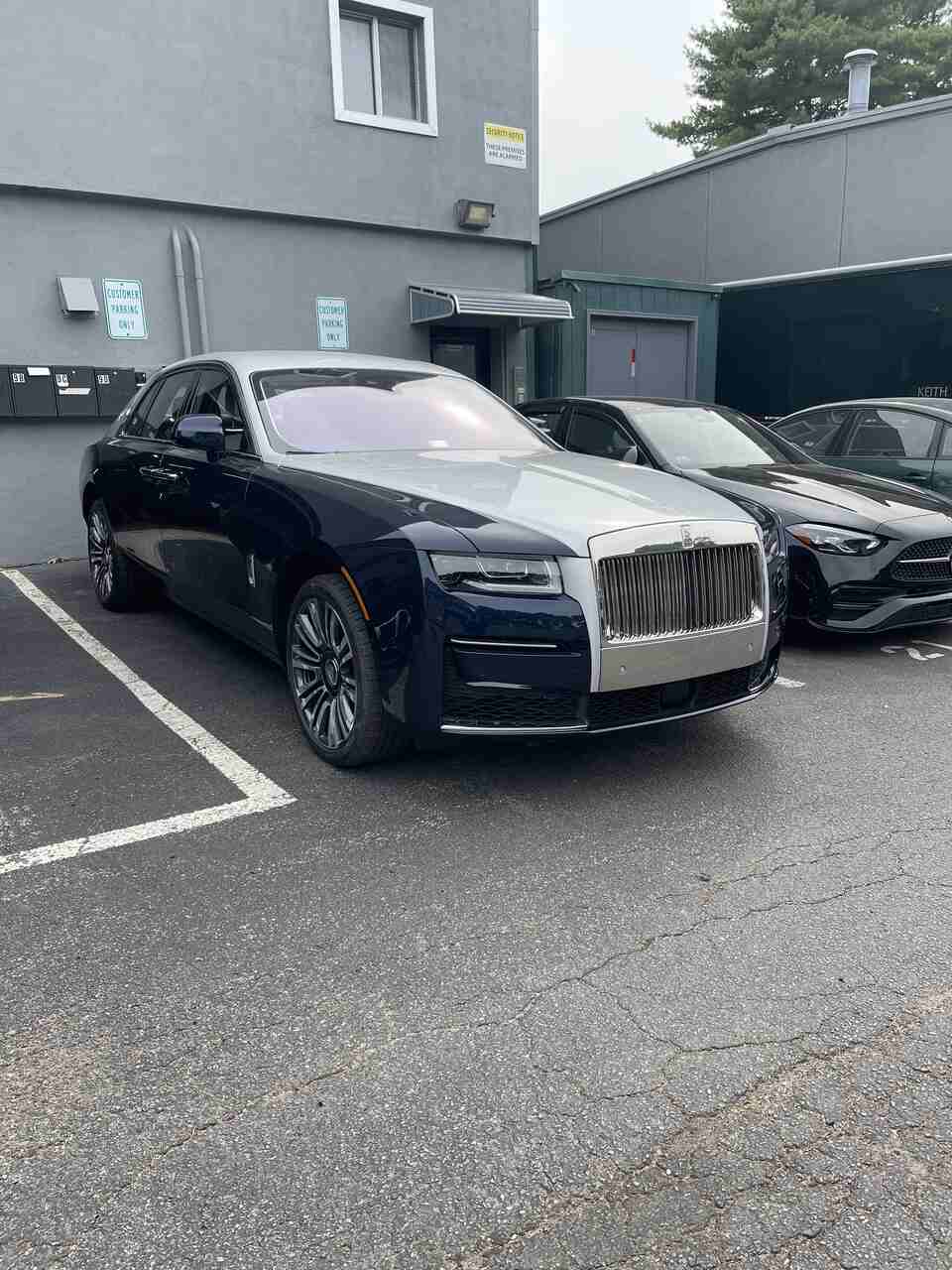 a car parked in a parking lot with a lot of other cars  serviced by Brake Pros of Waltham in Everett specializing in German car brake specialist.