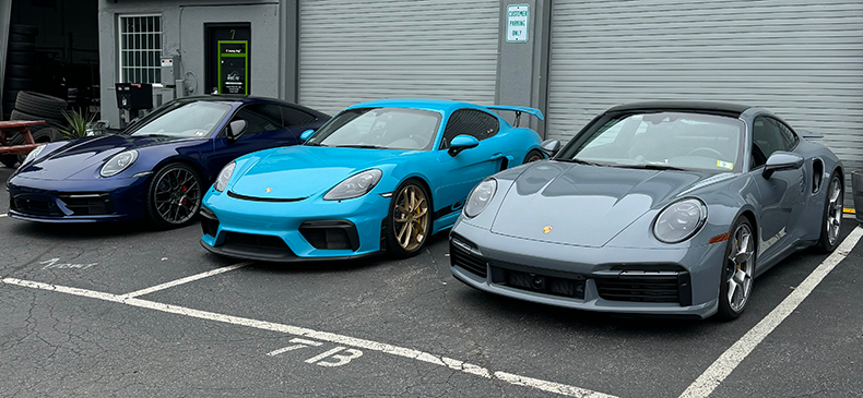 a blue car parked next to a white car  serviced by Brake Pros of Waltham in Dracut specializing in emergency brake repair.