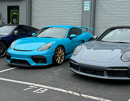 a blue car parked next to a white car  serviced by Brake Pros of Waltham in Dracut specializing in emergency brake repair.