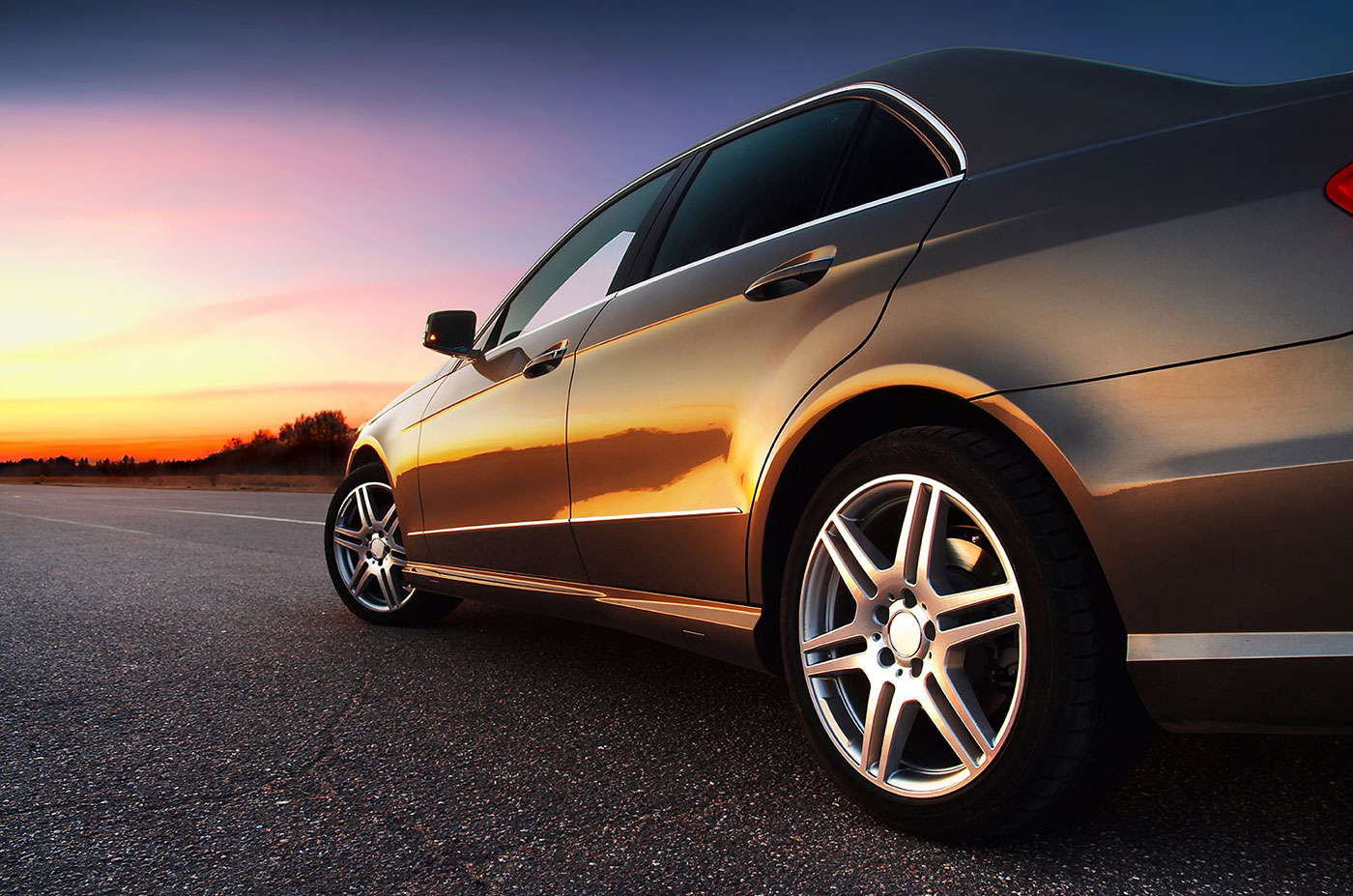 a car is parked in a parking lot  serviced by Brake Pros of Waltham in Arlington specializing in brake pad replacement.