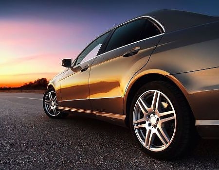 a car is parked in a parking lot  serviced by Brake Pros of Waltham in Arlington specializing in brake pad replacement.